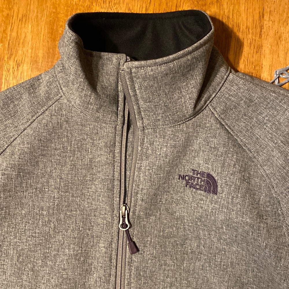 Grey zip up jacket from The North Face.